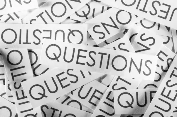 Black and white image of overlapping paper strips, each boldly printing the word QUESTIONS in capital letters. Some are upside down or sideways, mirroring the twists and turns one might encounter on a Pacific Crest Trail FAQ journey.