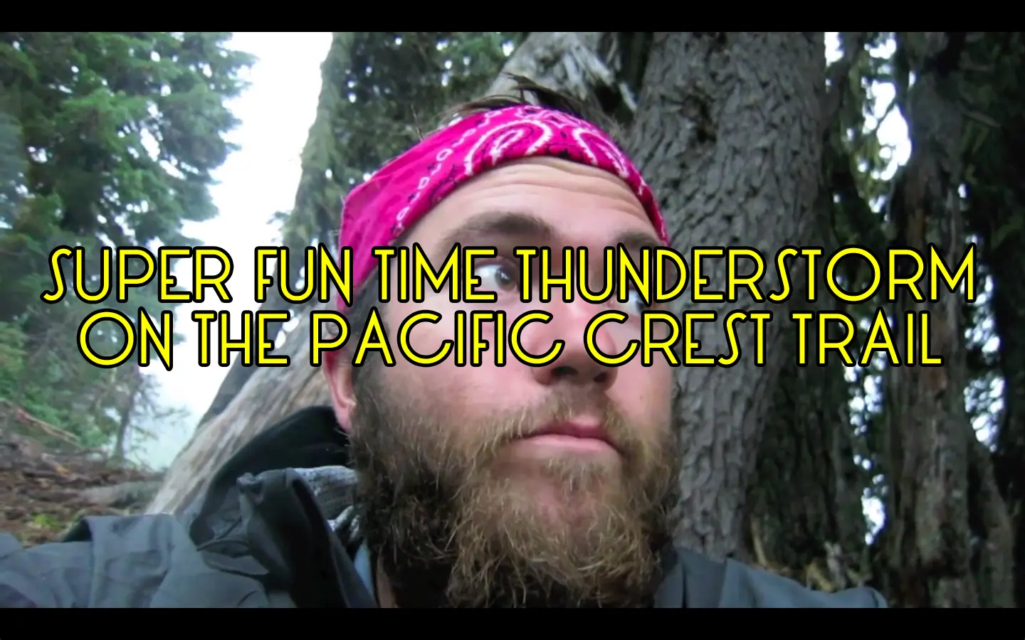 Bearded man wearing a pink bandana, sitting outdoors in a forested area along the famed Pacific Crest Trail. Text overlay reads, Super Fun Time Thunderstorm on the Pacific Crest Trail.
