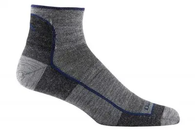 A single gray ankle sock with darker gray and black accents. This darn tough sock features a blue seam line along its side, complemented by blue detailing on the cuff and toe area.
