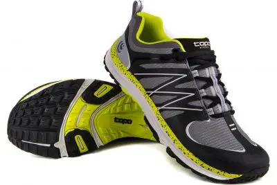 The Topo MT athletic shoes are showcased in black and gray with neon yellow accents and soles. One shoe stands upright, while the other is tilted to reveal its textured outsole. Featuring a mesh design and logo on the tongue and side, these shoes deliver both style and performance.