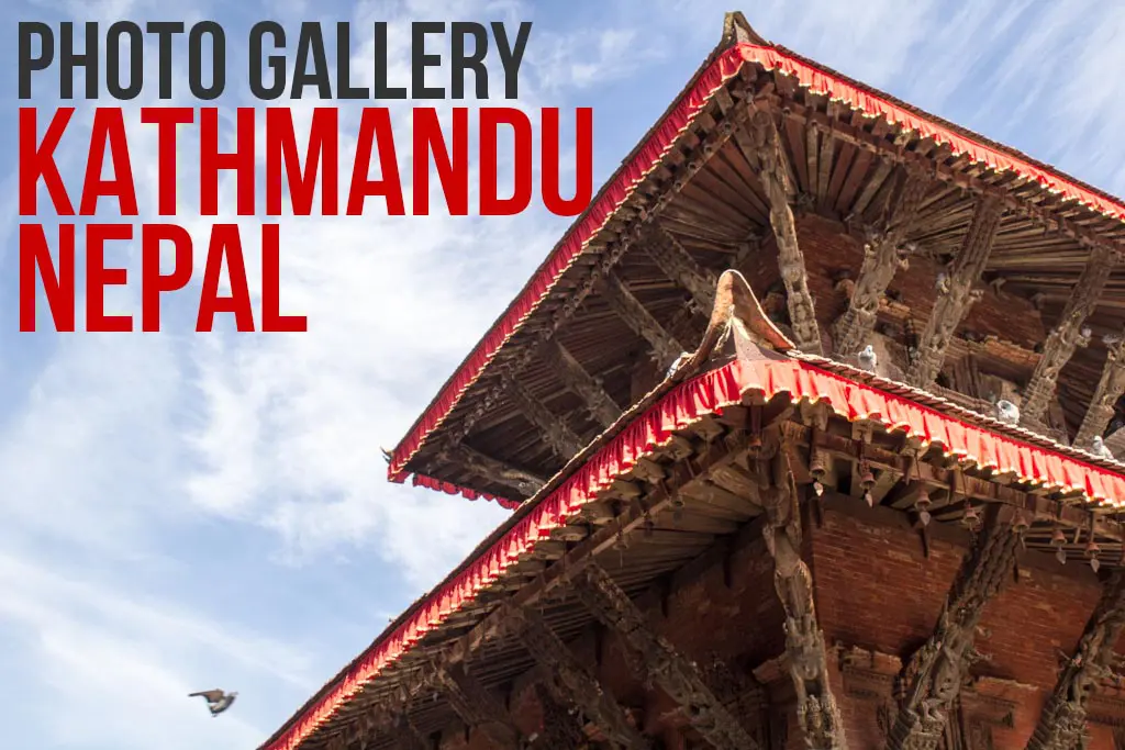 A traditional multi-tiered pagoda in Kathmandu, Nepal, set against a blue sky with clouds, showcases ornate wooden carvings. Nearby, a pigeon gracefully flies past. Bold text reading Photo Gallery Nepal overlays the image.