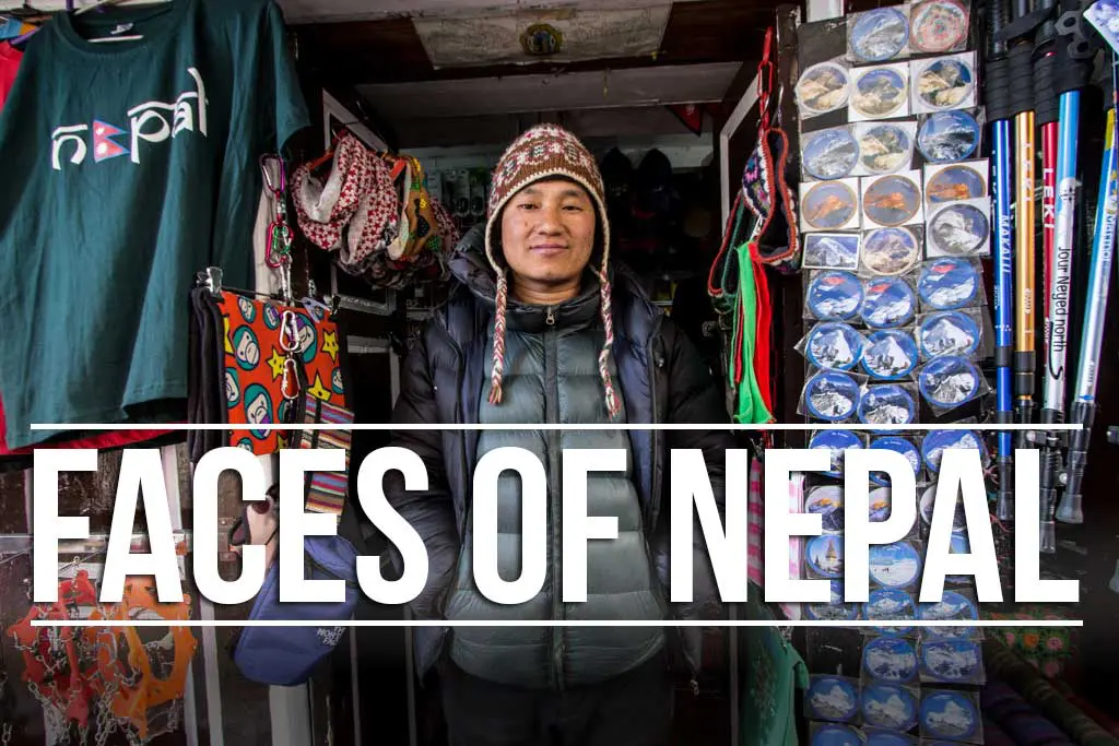 A person wearing a winter hat stands in a cluttered store entrance, surrounded by colorful shirts, bags, and merchandise that echo the vibrant spirit of Nepal. The text FACES OF NEPAL is prominently displayed, capturing the essence and diversity of life in the Himalayas.