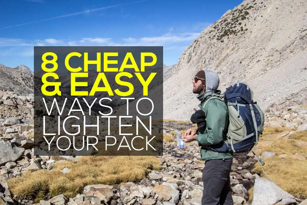 A hiker with sunglasses and a large backpack ventures across the rugged terrain, aiming to lighten pack for an easier trek. Text overlay reads, 8 Cheap & Easy Ways to Lighten Your Pack. Majestic mountains and a clear blue sky paint the backdrop.