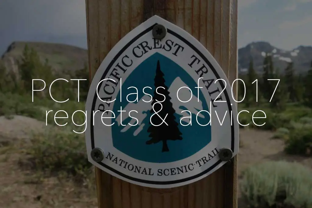A Pacific Crest Trail sign, featuring a tree emblem, is secured to a wooden post. Overlay text reads, PCT Thru-hikers: 2017 regrets & advice. A stunning mountainous landscape unfolds in the background.