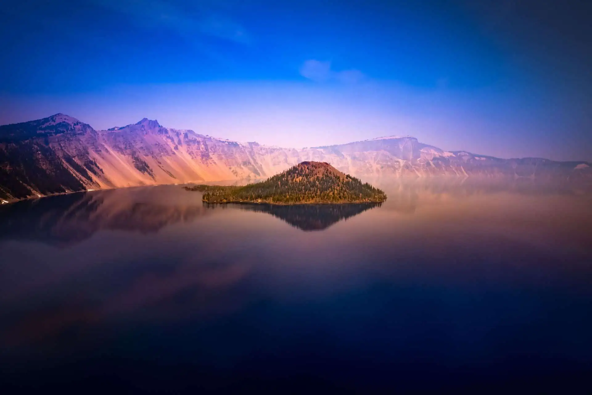 An island in the missdle of a lake at sunset