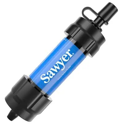 Image of a Sawyer personal water filter from the JMT Gear Guide 2024. The filter is cylindrical with a blue label and black caps on both ends, featuring a small spout and an attachment loop, perfect for portable water purification.