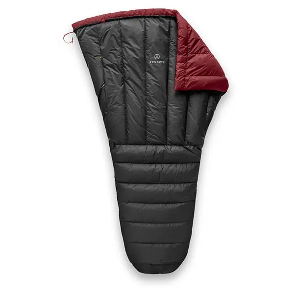 A black, mummy-style sleeping bag with a partial view of its red interior lining, featured in the JMT Gear Guide 2024. The brand logo is visible near the top, and it showcases horizontal quilting with a wide opening that tapers towards the bottom.