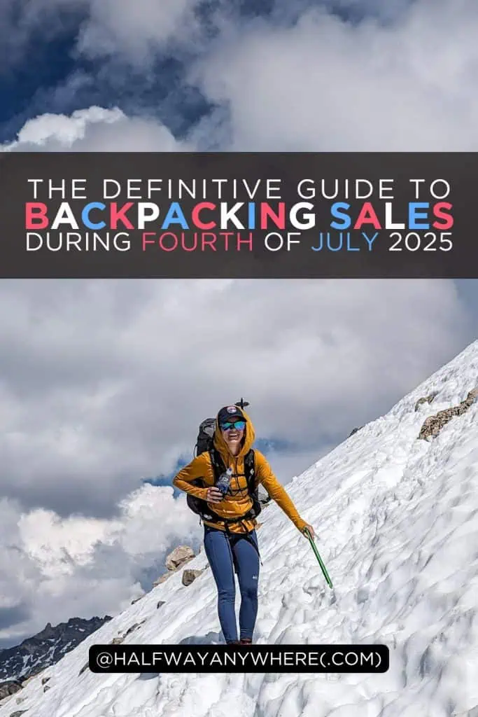 A hiker in a yellow jacket and blue pants climbs a snowy mountain slope under a blue sky. Text overlay reads: “The definitive Fourth of July sales guide for backpackers. @halfwayanywhere.com”.